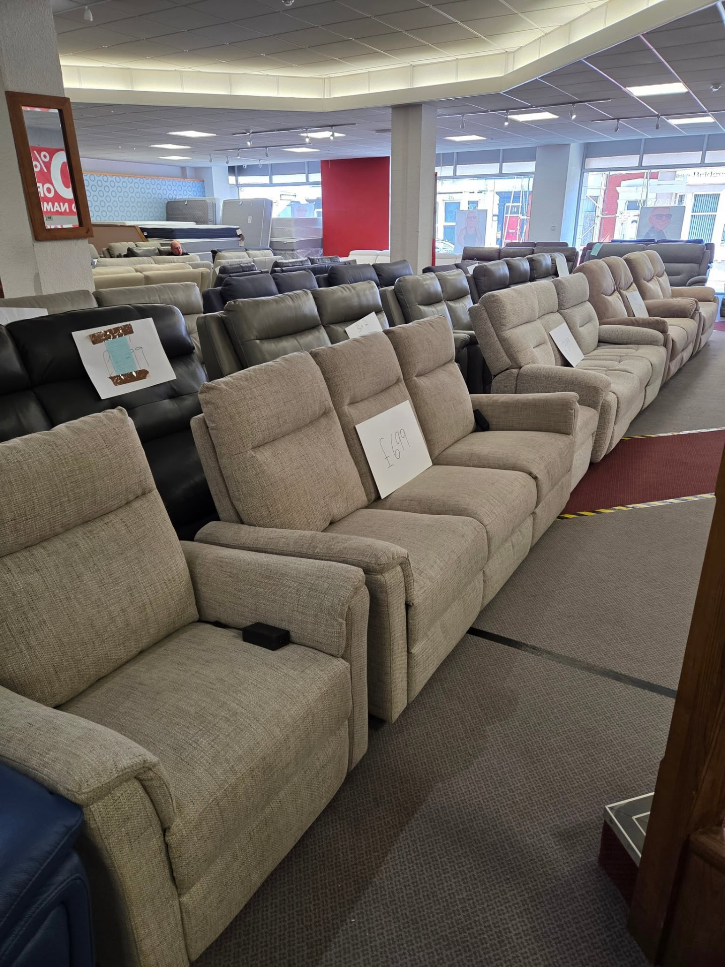 Rows of sofas and recliners on the Smart Mart showroom floor